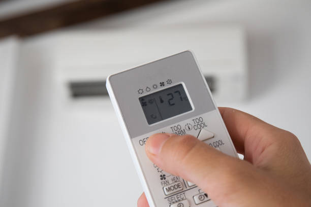 istock Hand turning on an air conditioning control, where 27 degrees are seen on the screen, as recommended by the new regulations of the Spanish government 1412535345