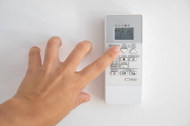 istock Hand turning on an air conditioning control, where 19 degrees are seen on the screen, as recommended by the new regulations of the Spanish government 1412535347