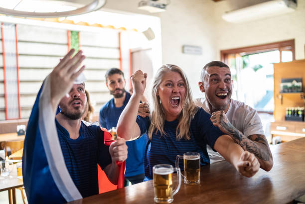 istock French team fans celebrating while watching a match in a bar 1412535528