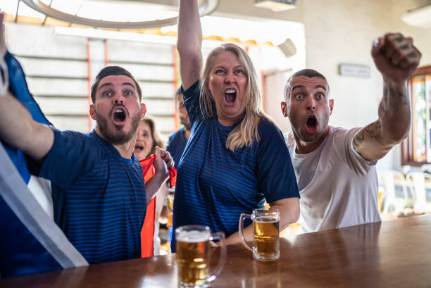 istock French team fans celebrating while watching a match in a bar 1412535537