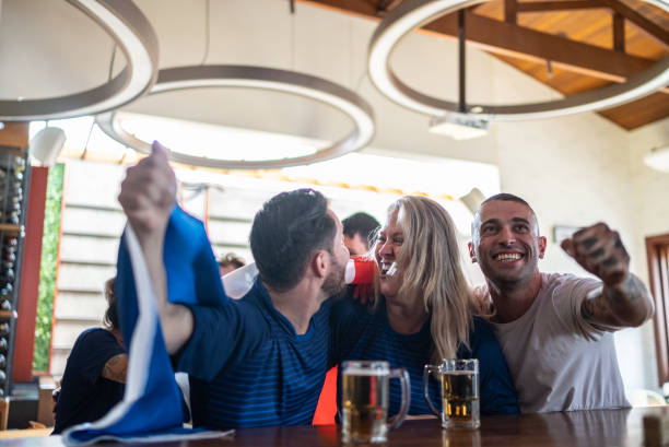 istock French team fans celebrating while watching a match in a bar 1412535555
