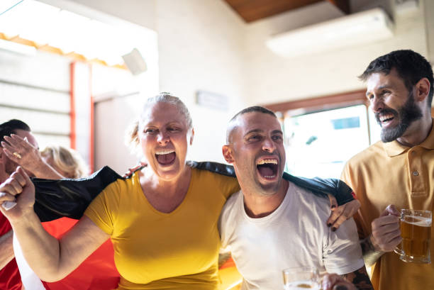 istock Friends celebrating German team winning in a bar 1412536487