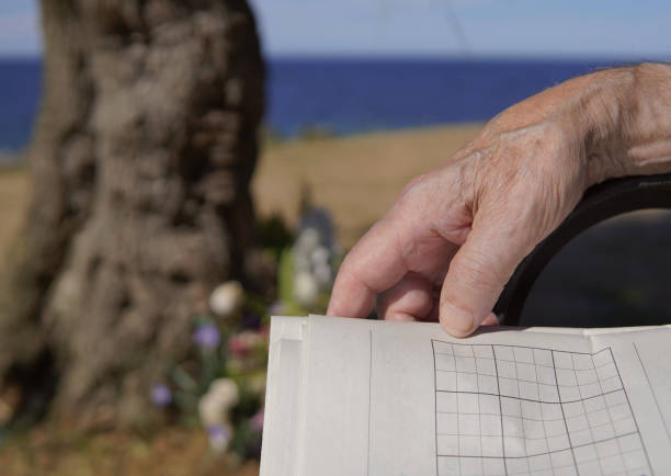 istock Retired man doing the pastime in the newspaper. 1412537604