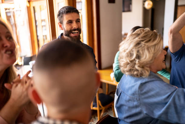 istock Happy friends watching a match and celebrating in a bar 1412538026