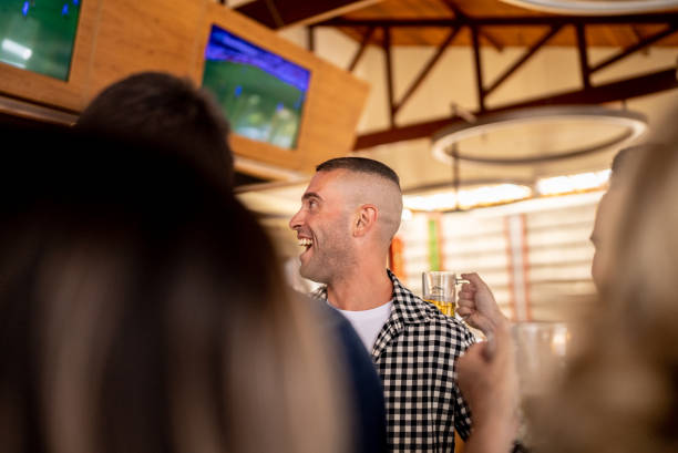 istock Friends watching match in a bar 1412538140