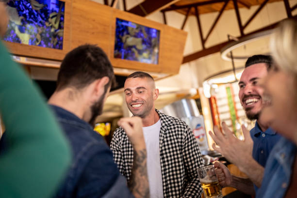 istock Happy friends talking and watching a match in a bar 1412538146
