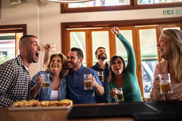 istock Friends watching a match and celebrating in a bar 1412538917