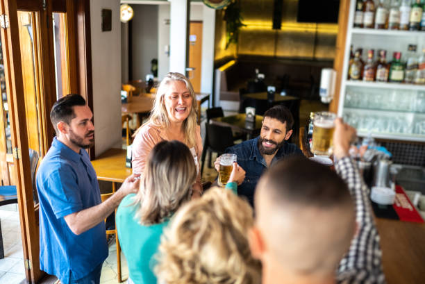 istock Friends talking and drinking in a bar 1412539092