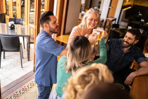 istock Friends toasting a beer and having fun at a bar 1412539202