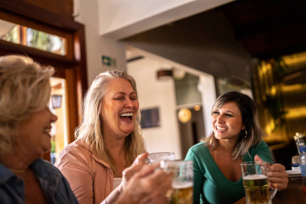 istock Female friends talking and having fun at a bar 1412539229
