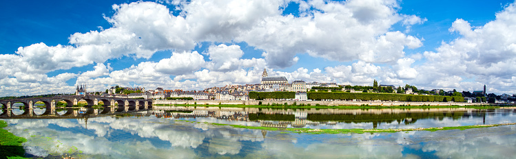 Blois, Loire Valley, France: Blois skyline, city on the shores of Loire River with Jacques Gabriel bridge, capital of Loir-et-Cher department in central France, dramatic cloudscape on sunny summer day