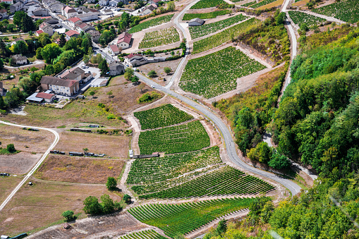 Aerial view of the vineyards of Cerdon small french wine village during a sunny summer day. This image was taken in Bugey, Alps mountains, in Ain, Auvergne-Rhone-Alpes region in France.