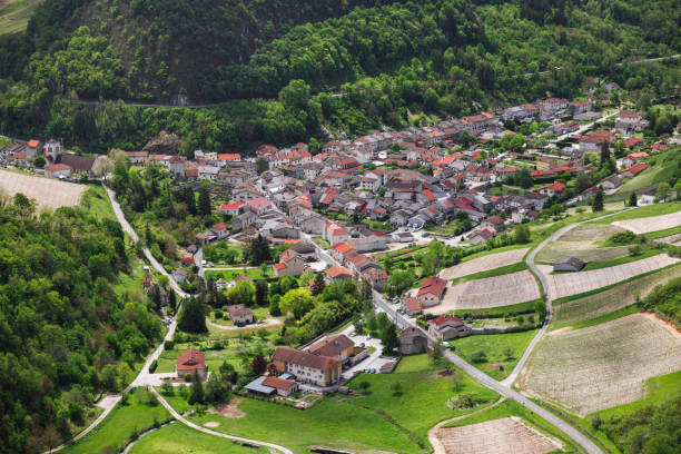 Aerial view of french idyllic wine village of Cerdon in the Ain valley in Bugey mountains in Alps Aerial view of Cerdon small french wine village during a sunny summer day. This image was taken in Bugey, Alps mountains near Jura massif, in Ain, Auvergne-Rhone-Alpes region in France. auvergne rhône alpes stock pictures, royalty-free photos & images