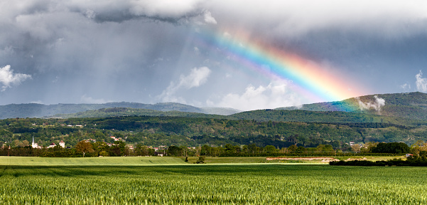 Rainbow and mountain hills. Beautiful sumer landscape