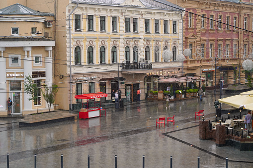 Nizhny Novgorod, Russia - June 19, 2022. Rain in the city. Tourist street Bolshaya Pokrovskaya in the rain