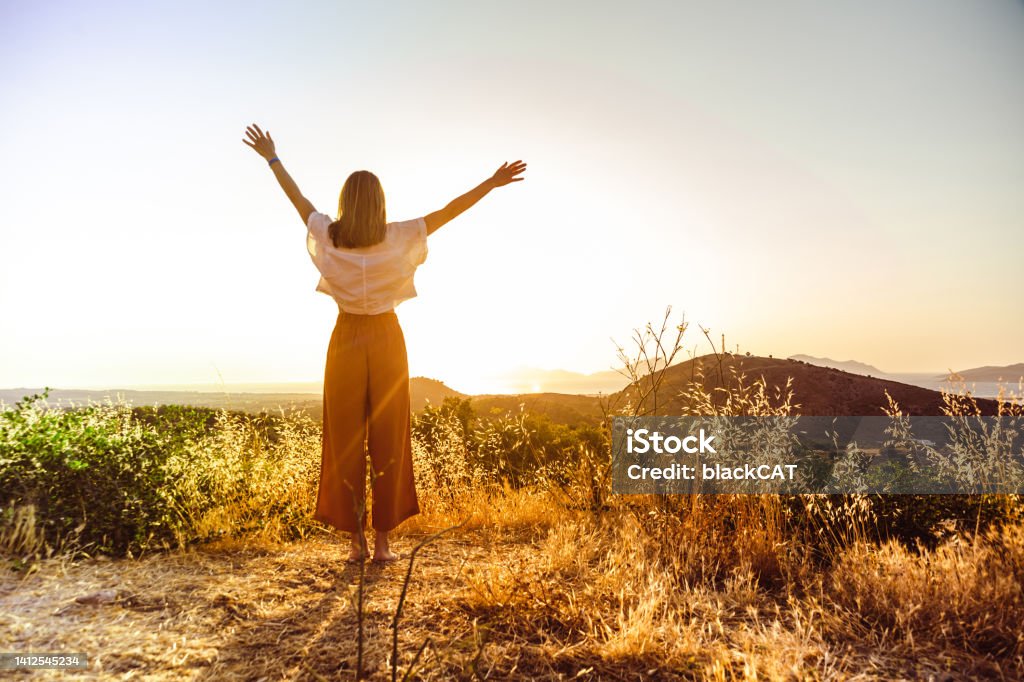 Feeling of freedom Young women enjoy the sunset and look at the view. Freedom concept Freedom Stock Photo