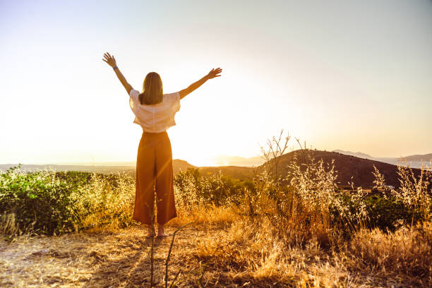 Feeling of freedom Young women enjoy the sunset and look at the view. Freedom concept arms outstretched stock pictures, royalty-free photos & images