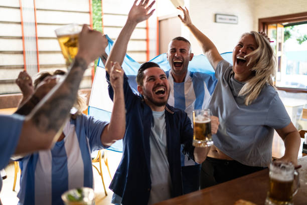 istock Sport team fans celebrating while watching a match in a bar 1412545401