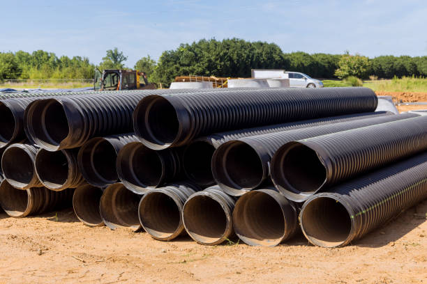 istock In order to build a drain system on a construction site, PVC new black plastic pipes are stacked in rows 1412546197