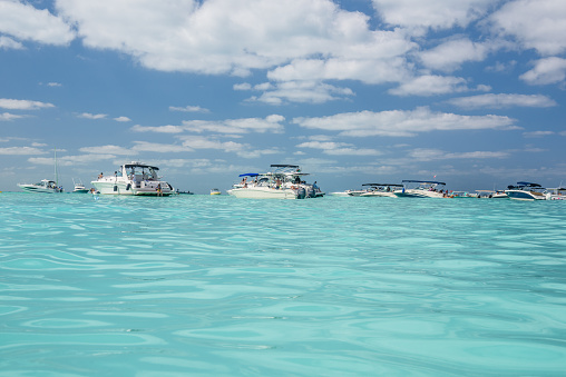 White speed boats and yachts in turquoise azure caribbean sea, Isla Mujeres island, Caribbean Sea, Cancun, Yucatan, Mexico.