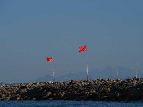 Bow of passenger ship named Weggis on Lake Lucerne with waving flag on a cloudy spring day. Photo taken May 18th, 2023, Lake Lucerne, Switzerland.