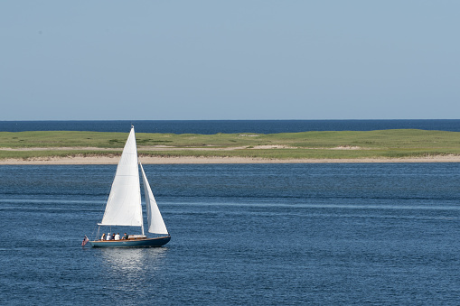 Chatham, Massachusetts: July 7, 2022: Group of people enjoying time on a sailboat near Chatham, Massachusetts