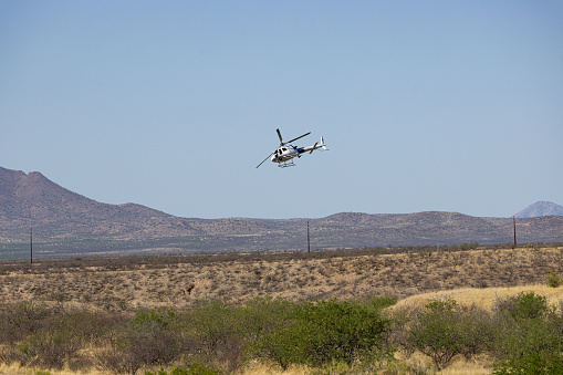 Border Protection Helicopter in pursuit in the desert south in Green Valley Arizona