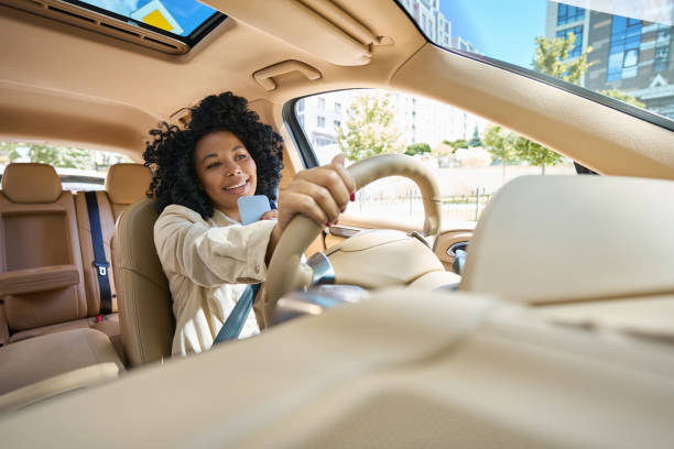 istock Female drives a comfortable car and talks on the phone 1412552492