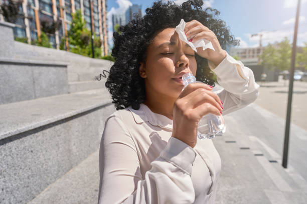 istock Woman overheated in the sun and dehydrated 1412552679