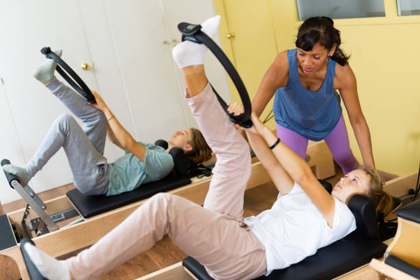 istock Teens training in pilates lessons led by female trainer 1412552703