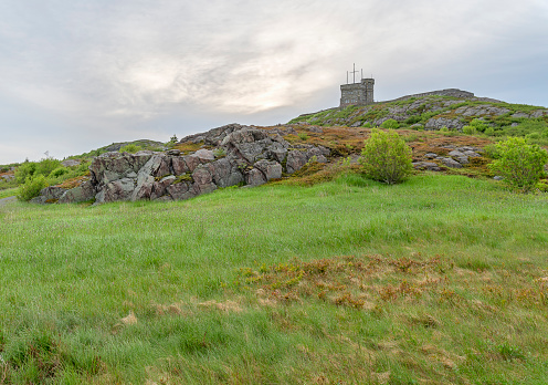 Rocky landscape with a distant view of the Cabot Tower National Historic Site on Signal Hill