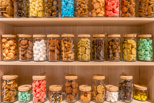 various of colorful, delicious and fresh cookies in jars for restaurant decoration