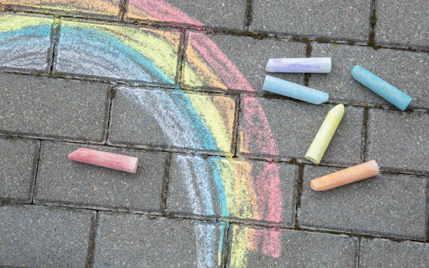 istock Rainbow painted in colored chalk on a path on the street 1412558188