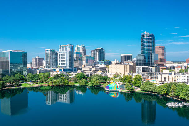 Orlando, Florida Skyline Aerial Aerial view of Orlando skyline and reflection in Lake Eola. orlando florida stock pictures, royalty-free photos & images