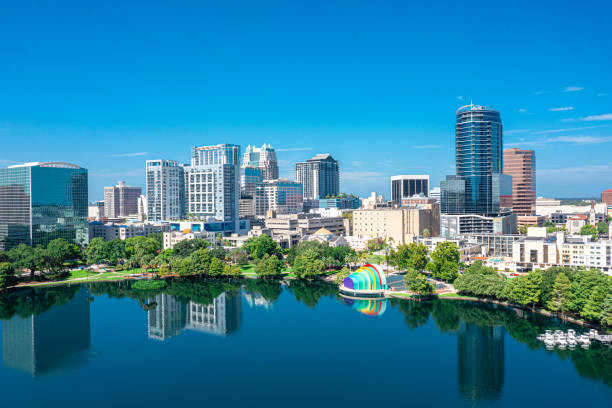 Orlando, Florida Skyline Aerial Aerial view of Orlando skyline and reflection in Lake Eola. reflection lake stock pictures, royalty-free photos & images