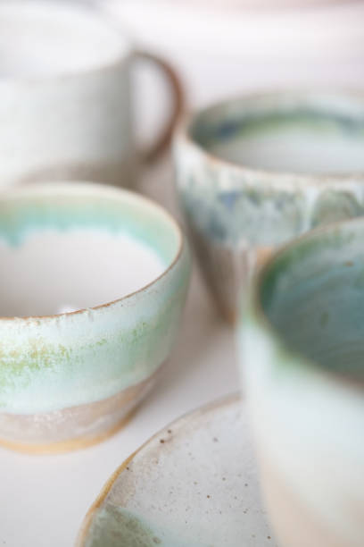 istock Turquoise handmade cups. Kitchen tea set on a white table. Minimalistic set of dishes 1412558485