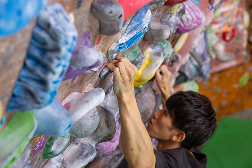 Bouldering athlete holding a stone using 