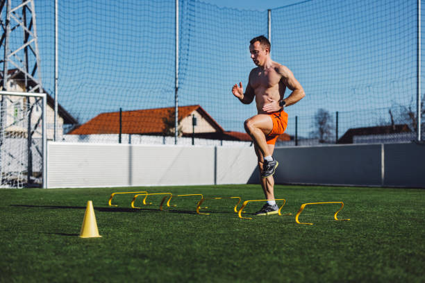 istock Shirtless athlete skipping over obstacles 1412562014