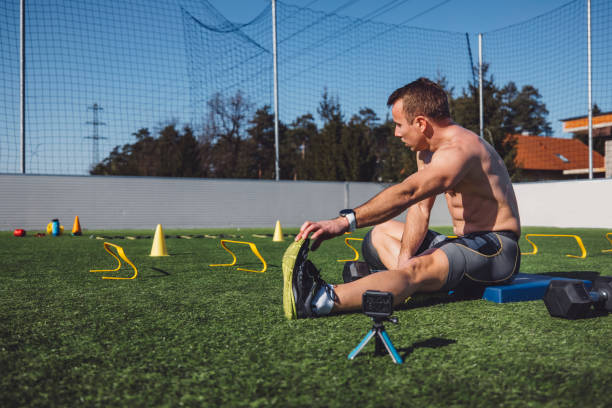 istock Athlete stretching his legs on the ground 1412562026