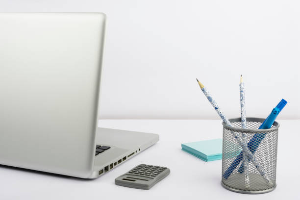 istock Lap Top, Case With Pencils And Markers, Calculator And Sticky Notes Placed On Desk. Computer, Colored Pens And Memos On Table. Office Suppies And Pc On Workspace. 1412562546