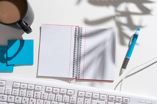 istock Notebook With Important Messages On Both Sides On Desk With Coffee, Pen, Notes And Keyboard. Crutial Information On Pad On Table With Cup, Memos And Pencil. 1412562629