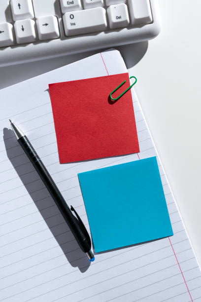 istock Sticky Notes With Important Messages Clipped On Opened Notebook On Desk With Pen And Keyboard. Crutial Informations Presented On Memos Attached On Notepad Next To Pencil. 1412562644