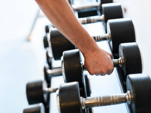 istock a young man working out weights at the gym 1412563723