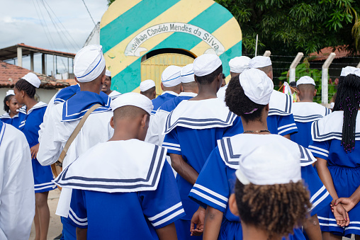 Saubara, Bahia, Brazil - August 03, 2019: Men, women and children, members of the cultural group CheganÃ§a dos Marujos, dance and sing in costumes during a performance at the streets of Saubara, Bahia.