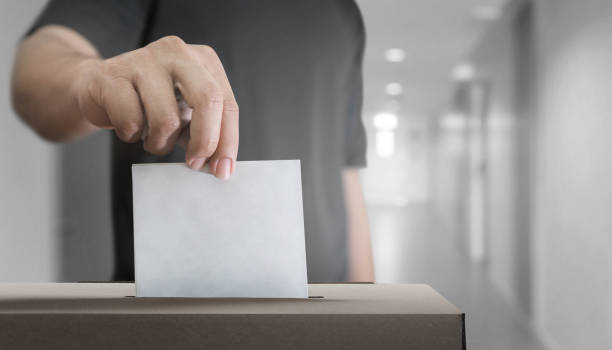 istock Hand holding ballot for election vote concept. 1412565953