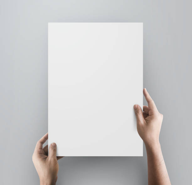 istock Old hands holding paper blank a4 size. 1412566112
