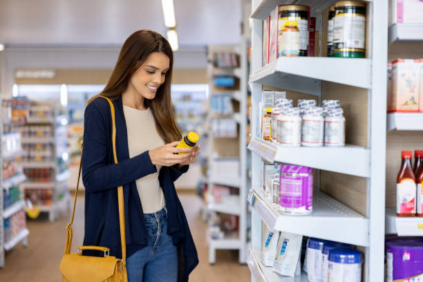 istock Woman buying nutritional supplements at the pharmacy 1412567385