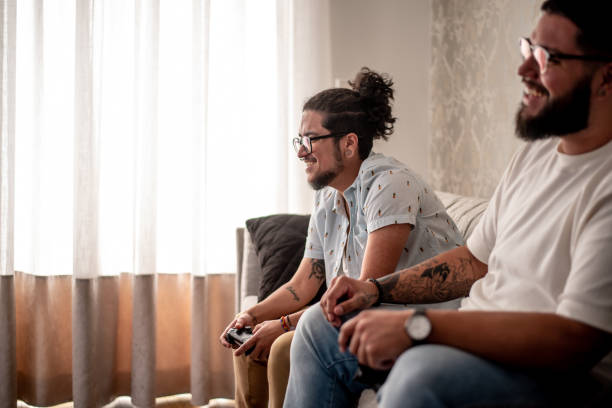 istock Two friends playing video games 1412567969