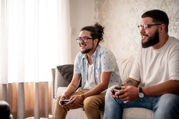 istock Two friends playing video games 1412567974