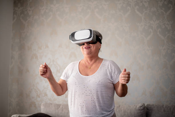 istock Mature woman playing with virtual reality glasses 1412568020
